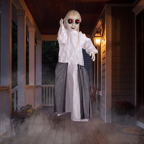 The hanging ghost decoration on a covered porch at night with fog around the hem and red LED eyes glowing